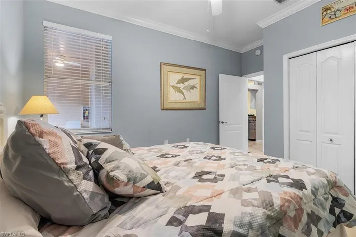 Bedroom with ornamental molding, a closet, and ceiling fan