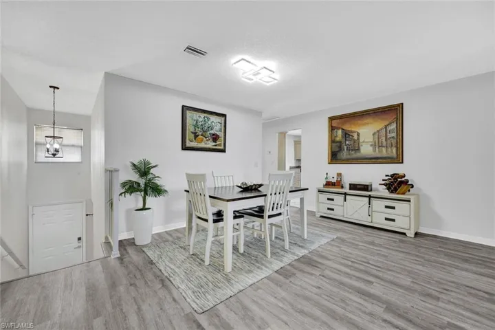 Dining room featuring light wood-type flooring and a chandelier
