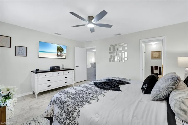 Bedroom featuring ceiling fan and baseboards