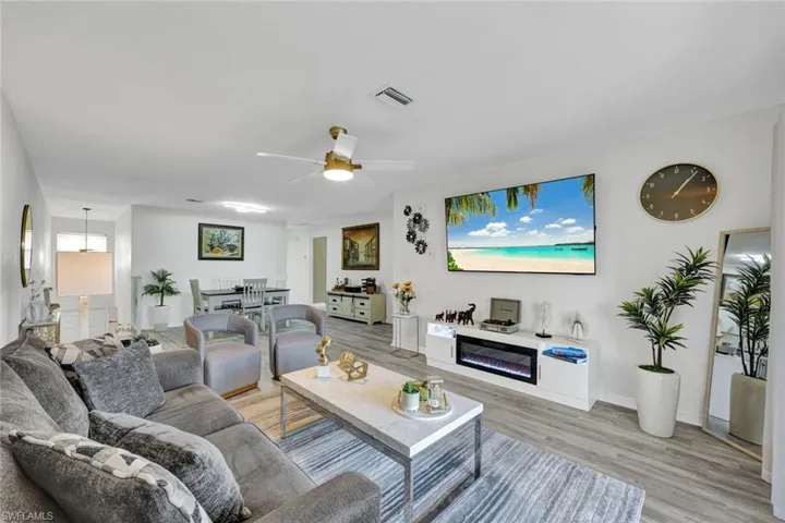 Living room featuring a ceiling fan and light wood-style floors