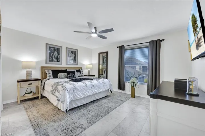 Bedroom featuring a ceiling fan and baseboards