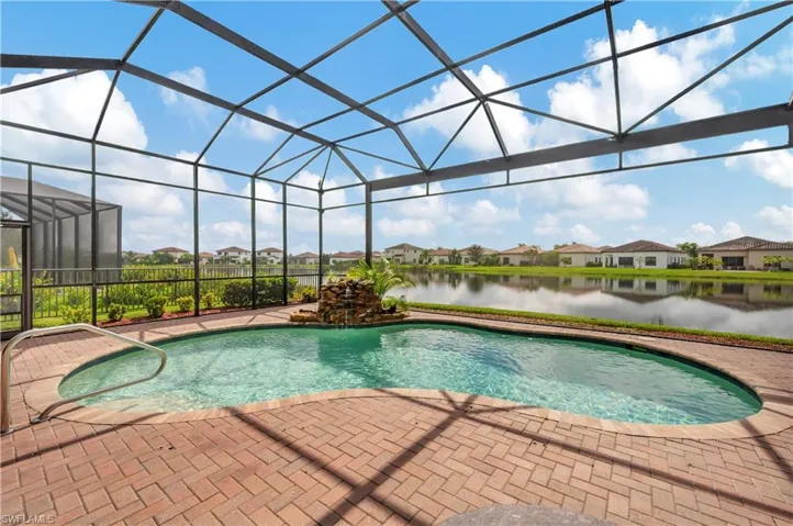 View of pool with a water view, a lanai, and a patio