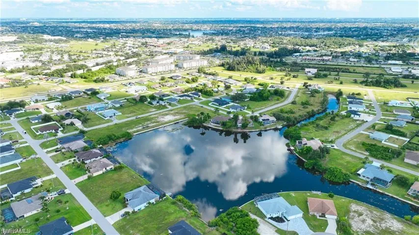 Aerial view of property and surrounding area featuring a large body of water