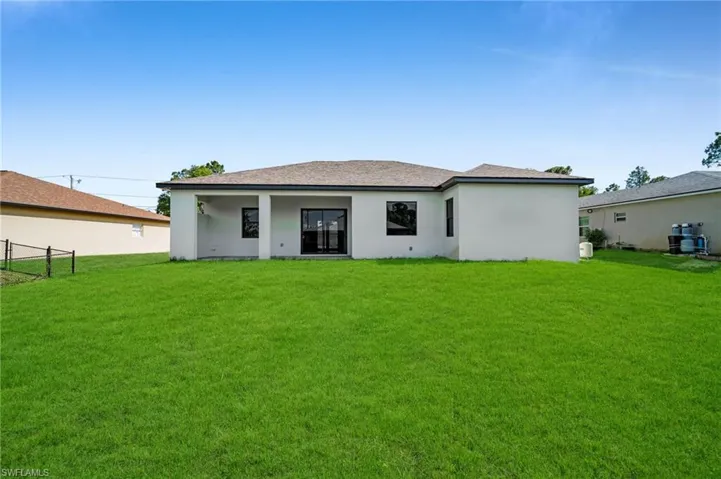 Back of house with stucco siding and a patio