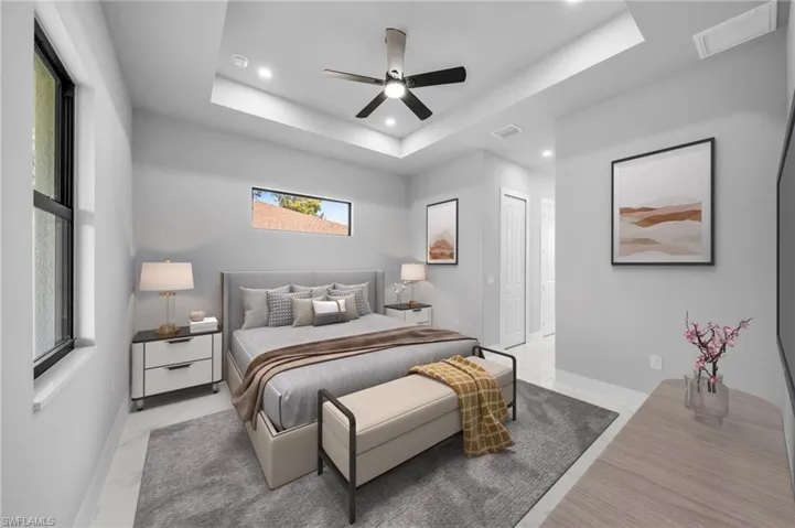 Bedroom featuring a ceiling fan, recessed lighting, a raised ceiling, and a closet