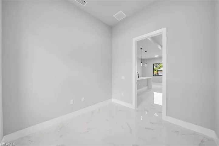 Empty room featuring baseboards and light marble finish flooring