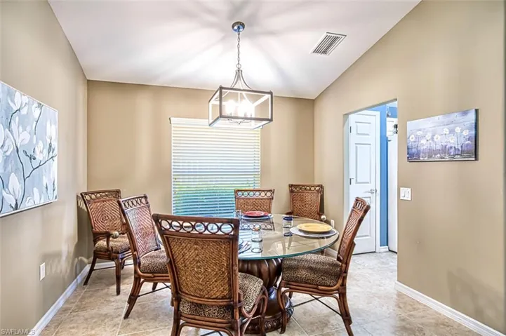 Dining area with a chandelier and light tile patterned floors