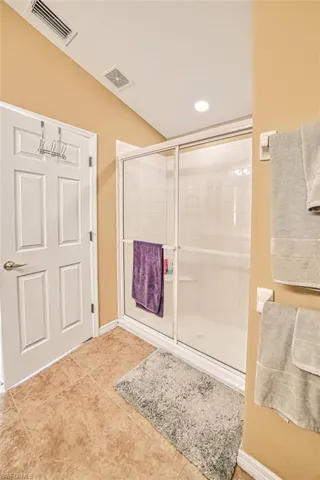 Full bathroom with a shower stall, tile patterned flooring, and recessed lighting