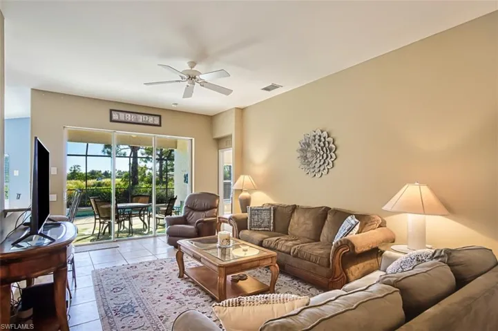 Living area with light tile patterned flooring and a ceiling fan