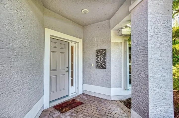 Entrance to property with stucco siding