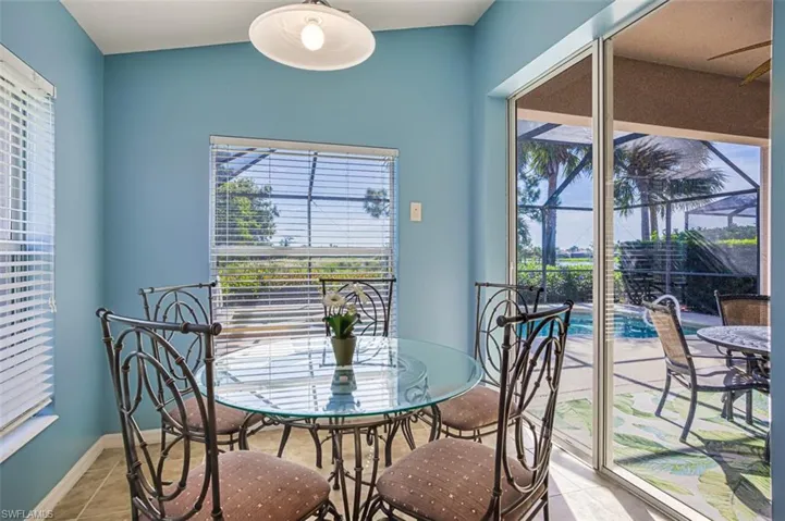 Dining space featuring tile patterned flooring, a sunroom, healthy amount of natural light, and ceiling fan