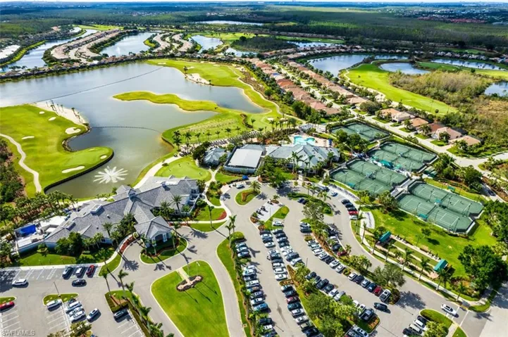 Aerial view of property's location featuring a golf club and a nearby body of water