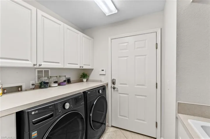 Laundry with fairly new front load washer & dryer