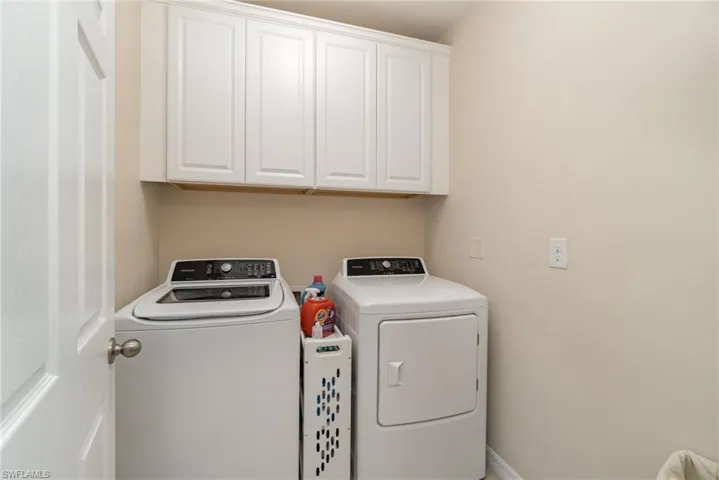 Laundry room with cabinets and separate washer and dryer
