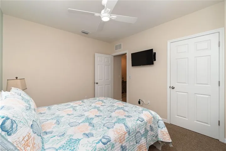 Bedroom with ceiling fan and carpet floors