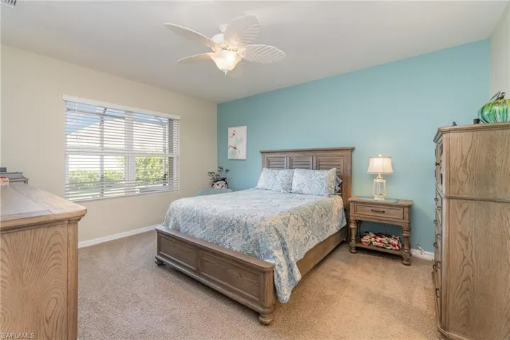 Carpeted bedroom with ceiling fan