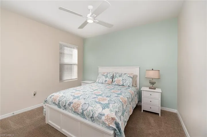 Bedroom with ceiling fan and carpet