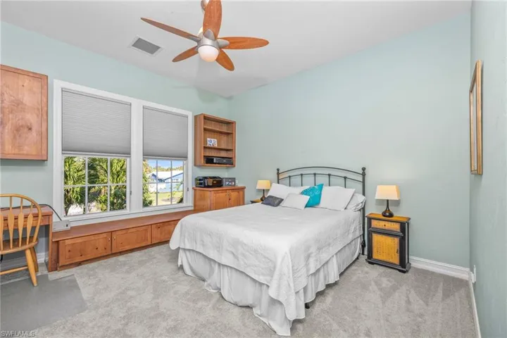 Carpeted bedroom with ceiling fan