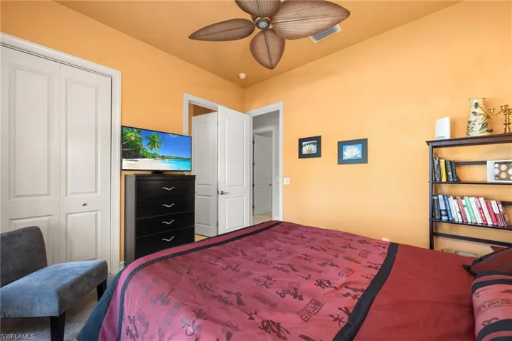 Bedroom with ceiling fan, vaulted ceiling, and a closet