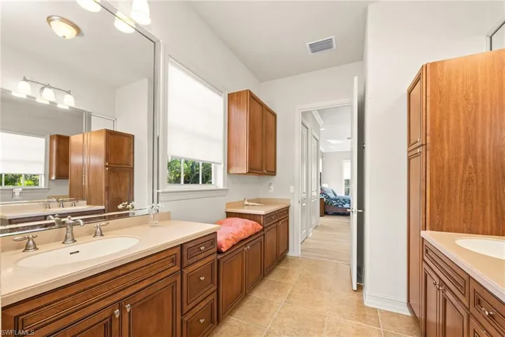 Bathroom featuring  dual vanities and tile patterned floors