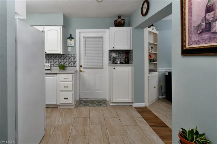 Kitchen with outdoor entry door.