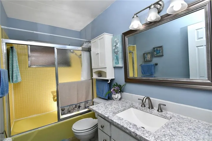 Second bathroom with granite countertop.