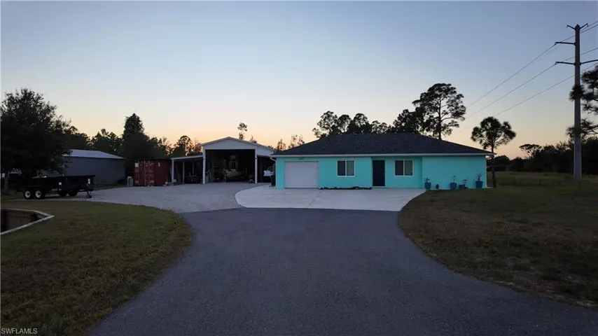 Single story home with driveway, a front lawn, an attached garage, and stucco siding