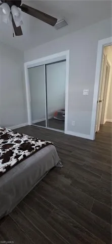 Bedroom #2 featuring dark wood-style floors, a closet, and a ceiling fan