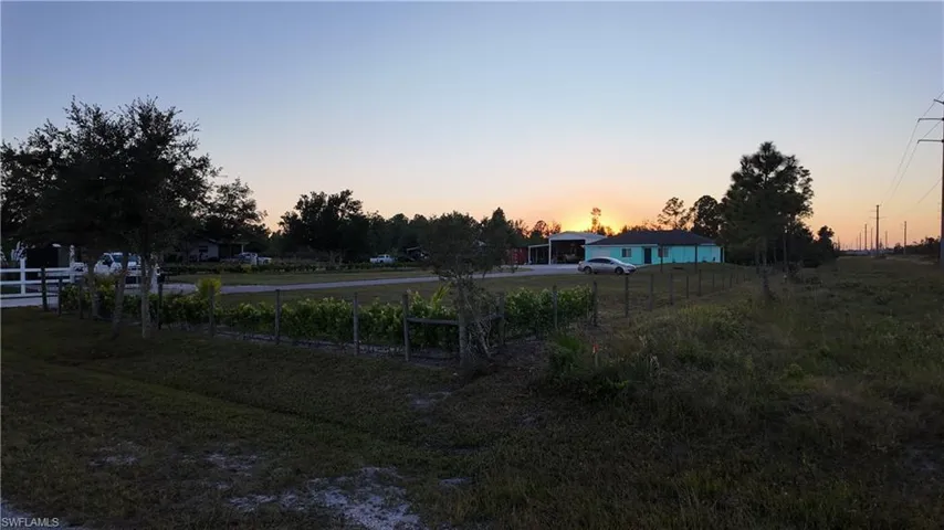 Yard at dusk featuring a view of countryside