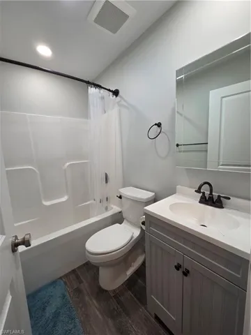 Guest Bathroom with shower / bath combo with shower curtain, vanity with recessed lighting