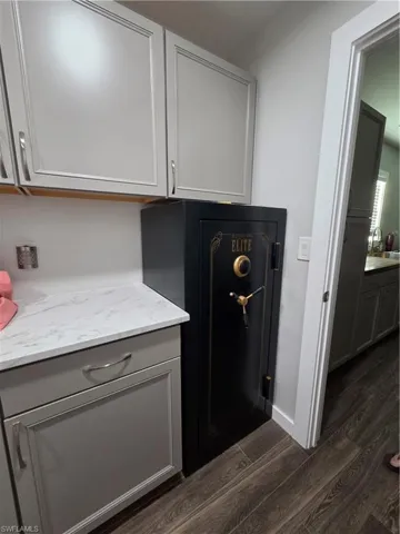 Laundry view of safe of porcelian tiled floors