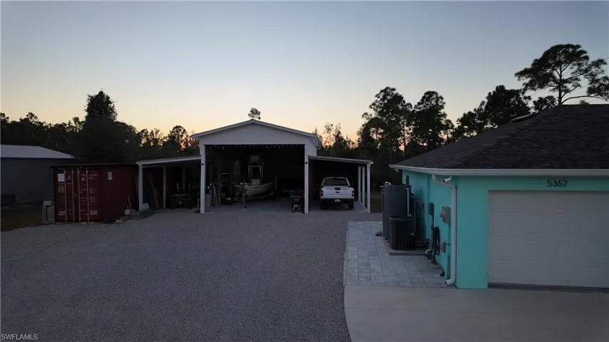 Garage with driveway and pole barn