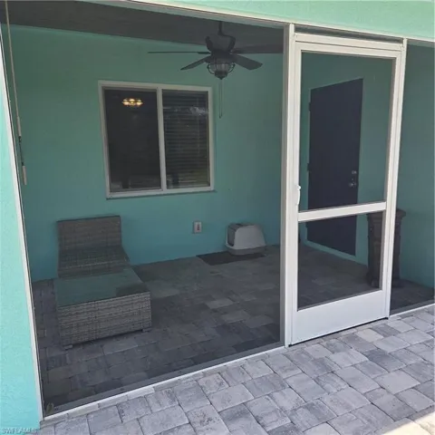 View of screened lanai with a ceiling fan and tonque & groove ceiling.  12'x50 paver patio