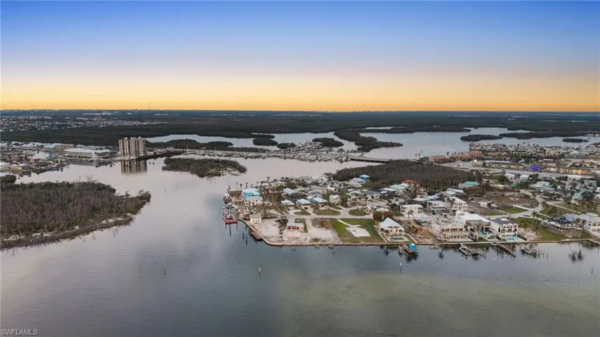 Aerial view at dusk featuring a water view