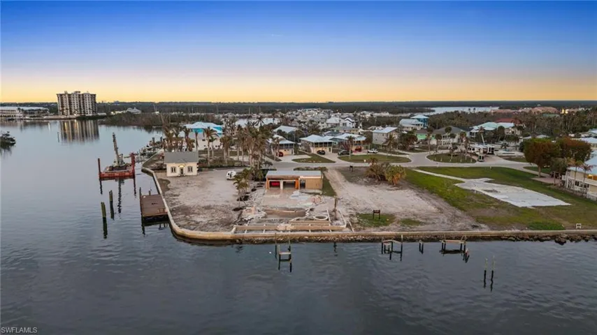 Aerial view at dusk featuring a water view