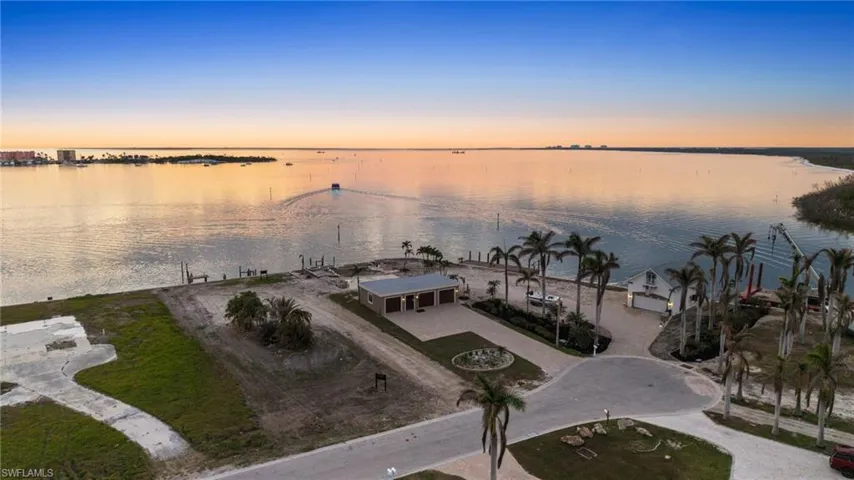 Aerial view at dusk featuring a water view