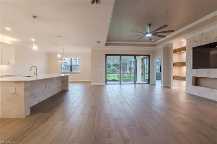 Spacious open-concept interior featuring light wood-finish flooring throughout