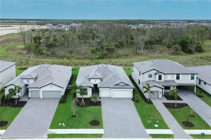 Contemporary residences featuring a combination of single and two-story designs, neutral exterior finishes, grey tile roofs, paved driveways, and manicured landscaping