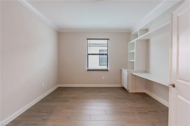 Spacious garage featuring a light gray epoxy floor and white walls