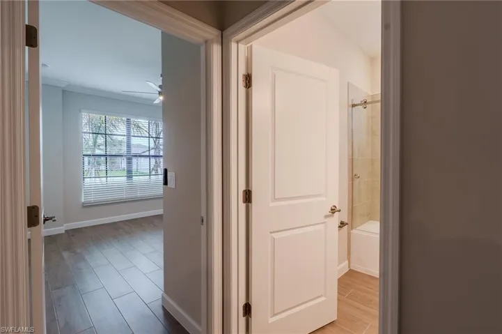 Modern bathroom featuring a single vanity with a white countertop, undermount sink, and brushed nickel hardware