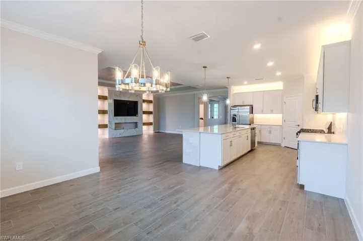 Spacious open-concept interior featuring light wood-finish flooring throughout