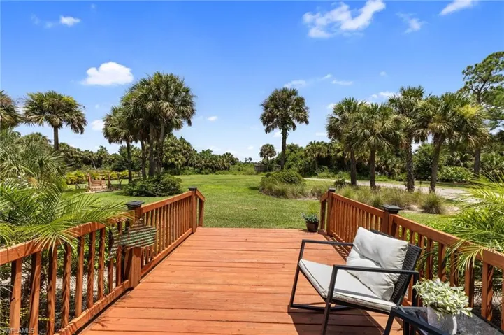 Wooden terrace featuring a lawn