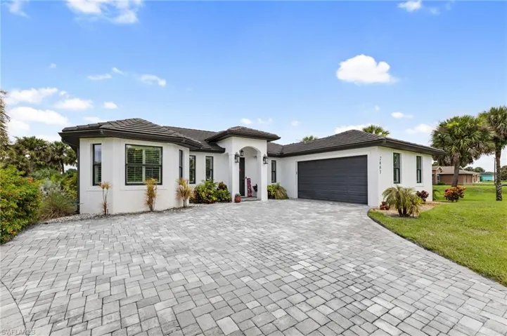 View of front of home featuring a garage and a front yard