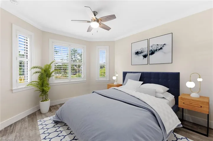 Bedroom featuring   new floors,crown molding, and ceiling fan