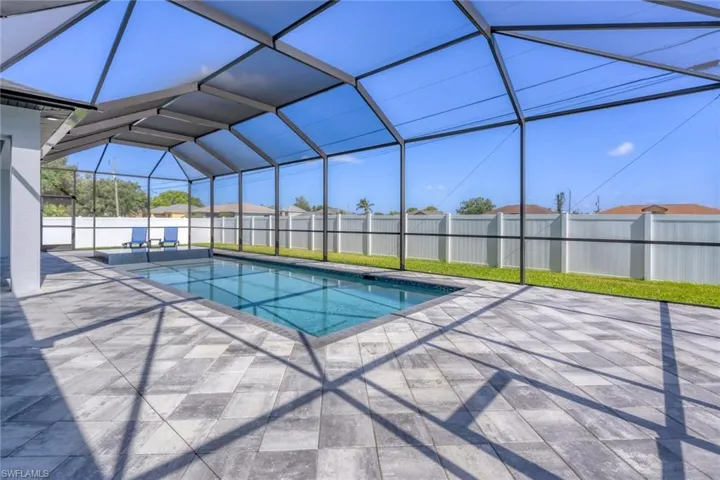 View of pool featuring a patio area and a lanai