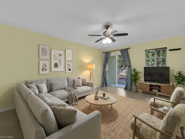 Tiled living room featuring crown molding and a ceiling fan