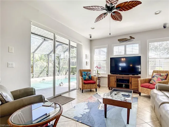 Light, airy family room, plantation shutters and sliders leading out to pool.