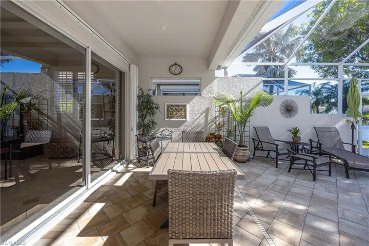 View of patio featuring glass enclosure