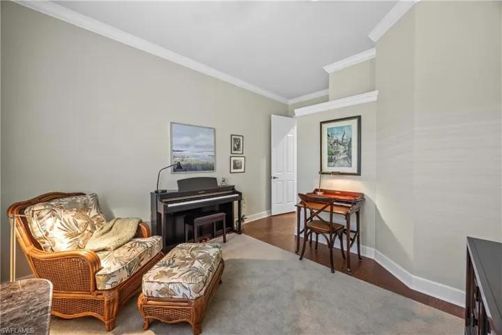Sitting room featuring hardwood / wood-style flooring and crown molding