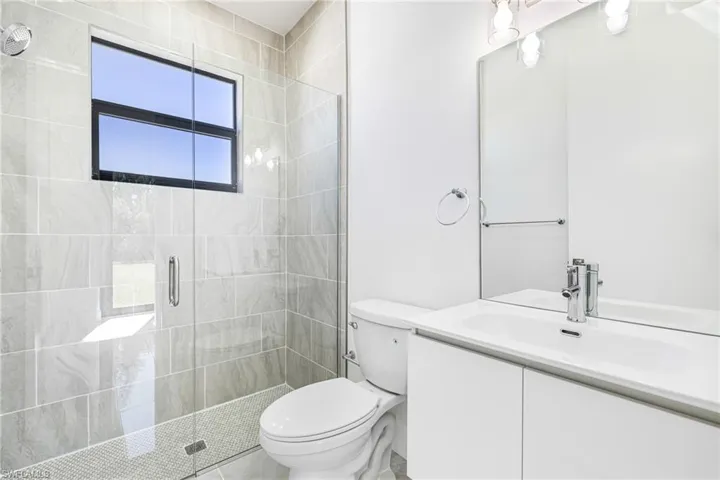 Bathroom with a stall shower and vanity